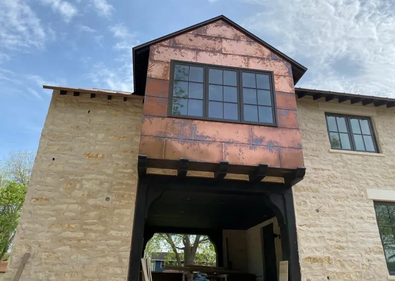 Copper metal panel facade on a stone building for Metal Roof Coating in Saraland