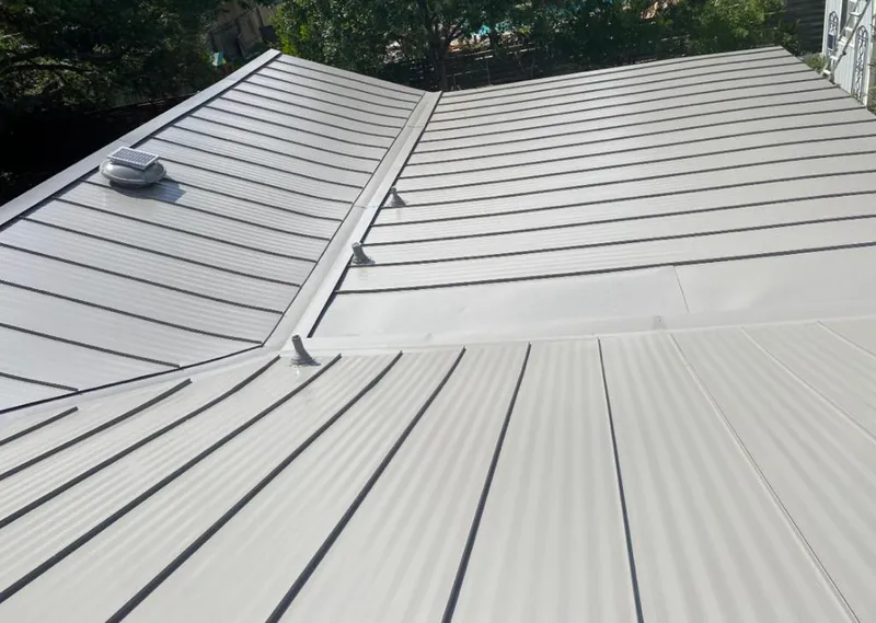 Solar attic fan installed on a metal roof for Roof Ventilation in Saraland